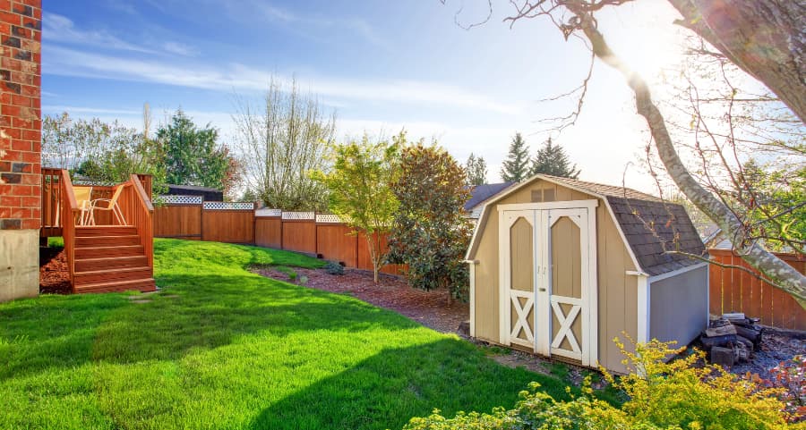 Fenced backyard with storage shed in South Fulton